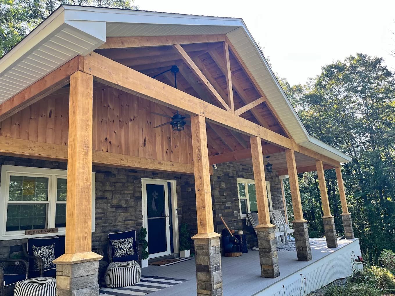 Covered timber-frame porch by A&E Home Improvement in Lakes Region, NH
